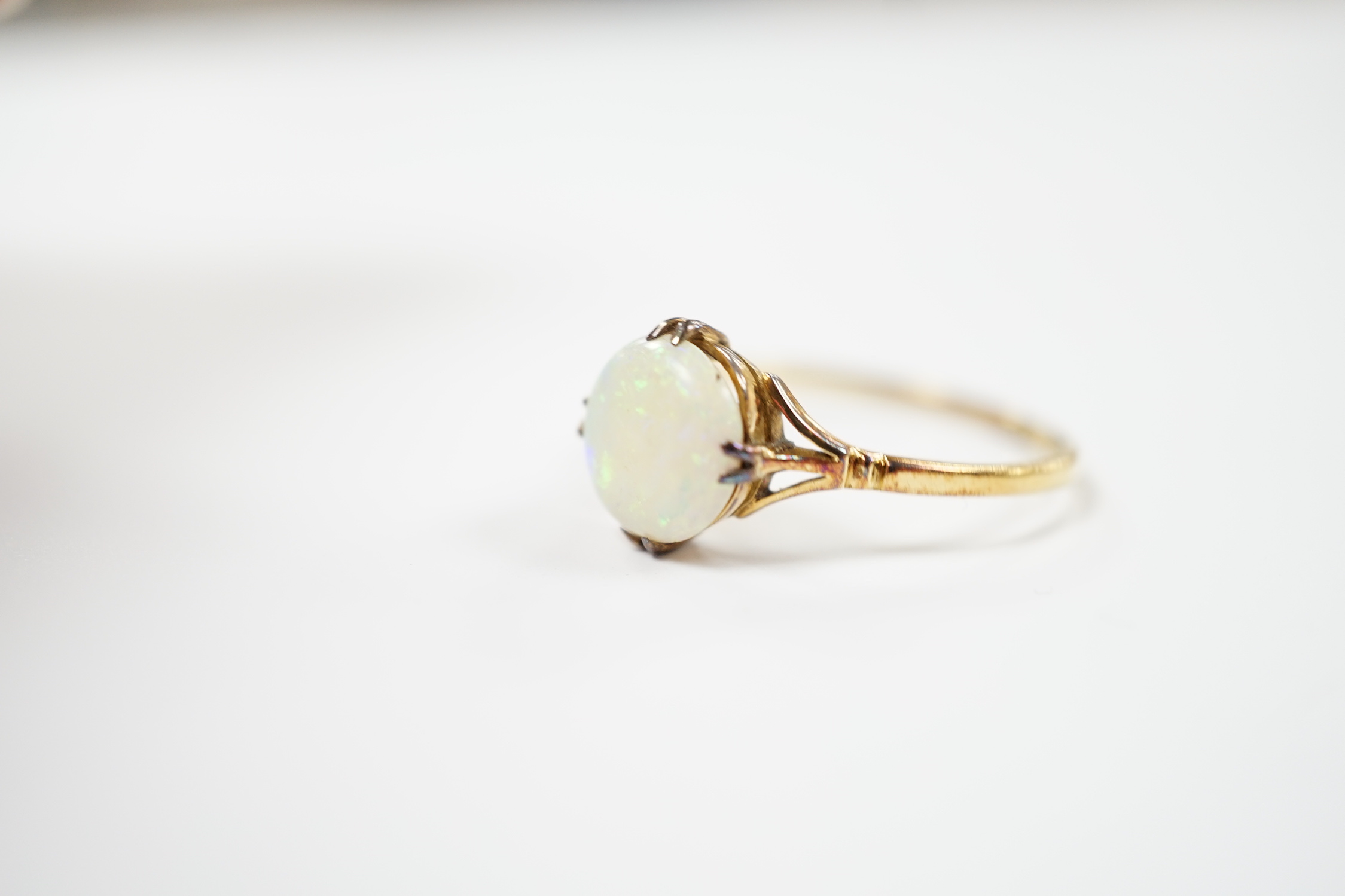 An 18ct and single stone white opal set ring, size S, gross weight 2.5 grams.